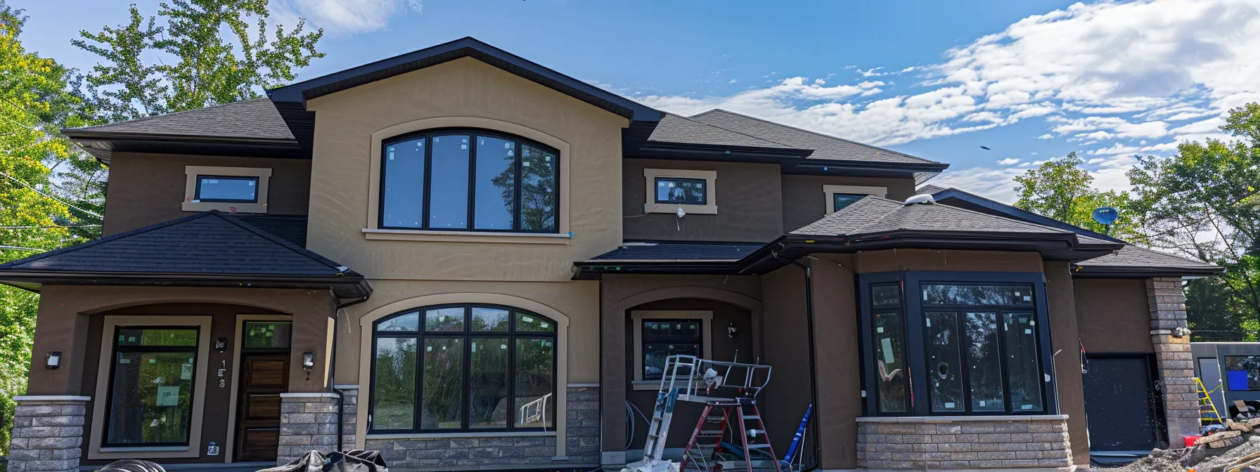 a house in ingersoll, ontario with stucco exterior and acrylic paint being sealed with silicone-based sealants to protect against harsh weather.
